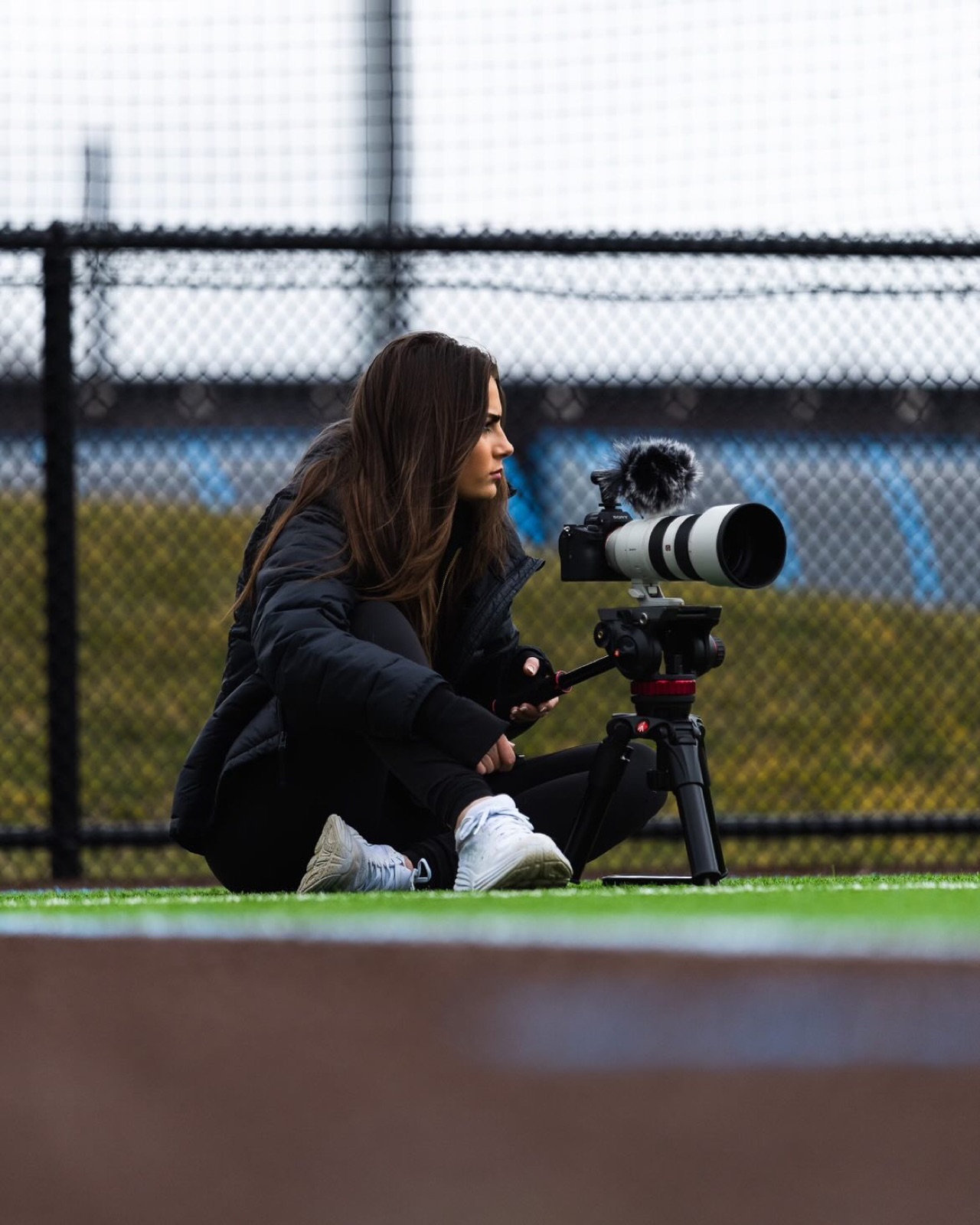 Kate Sardone — graduate portrait in commencement stole beneath a stone arch