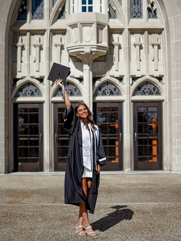 Graduate raising cap in celebration